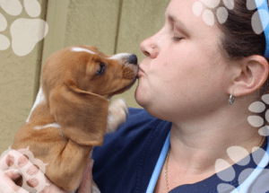 Tech getting puppy kisses