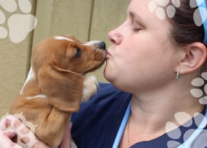 Tech getting puppy kisses